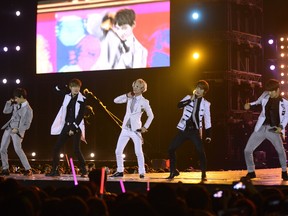 Members of SKorea's K-pop band FT Island perform during a concert held at Hanoi's My Dinh stadium on November 29, 2012.