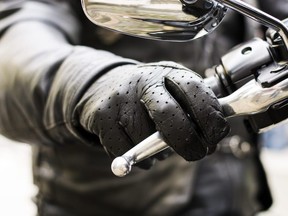 Biker's hand on brake lever handlebar