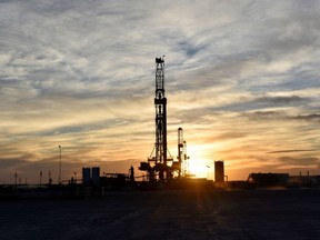 Drilling rigs operate at sunset in Midland, Texas, U.S., February 13, 2019.