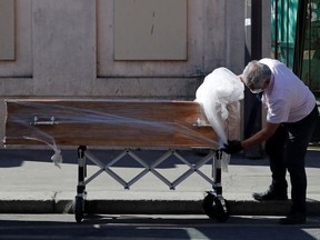 An employee delivers a coffin at the Fondation Rothschild retirement home (Ehpad) in Paris where 16 residents have died and 81 have been infected with coronavirus disease (COVID-19) as the spread of the coronavirus disease (COVID-19) continues in France, March 25, 2020.