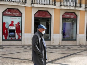 A man wearing a mask is seen, in downtown Lisbon, Portugal March 16, 2020.