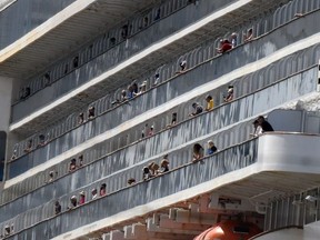 People watch embarkation preparations being made aboard the Grand Princess cruise ship carrying passengers who have tested positive for coronavirus docked at the Port of Oakland in Oakland, California, U.S. March 9, 2020.