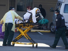 A patient is wheeled to an ambulance during the outbreak of Coronavirus disease (COVID-19), in the Manhattan borough of New York City, New York, U.S., March 26, 2020.