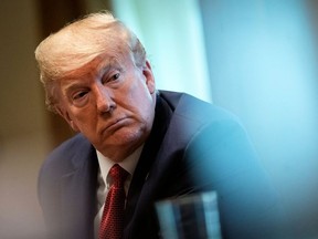 U.S. President Donald Trump listens during a meeting with supply chain distributors in the Cabinet Room of the White House in Washington, U.S., March 29, 2020.