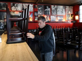 Raul Gonzalez, Jr., 53 stacks chairs at his Mambos Cuban restaurant, which is being forced to close after 32 years, due to the global outbreak of the coronavirus disease (COVID-19), in Glendale, California, U.S., March 18, 2020.