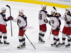 The Columbus Blue Jackets celebrate their win against the Vancouver Canucks during the third period at Rogers Arena.