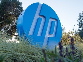 In this file photo taken on Nov. 4, 2016, the HP logo is seen on a sign at Hewlett Packard's headquarters in Palo Alto, Calif.