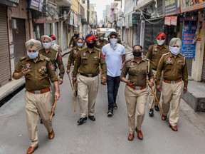 Police patrol on a street during a government-imposed lockdown as a preventive measure against the COVID-19 coronavirus, in Amritsar on March 24, 2020. (NARINDER NANU/AFP via Getty Images)