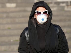 A person wears a protective face mask, on the third day of an unprecedented lockdown across of all Italy imposed to slow the outbreak of coronavirus, in Naples, Italy, on Thursday, March 12, 2020.