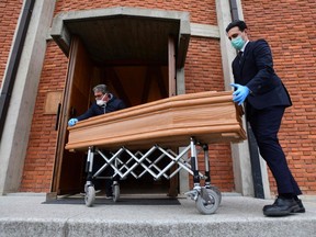 Pallbearers bring the coffin of a deceased person to be stored into the church of San Giuseppe in Seriate, near Bergamo, Lombardy, on March 26, 2020. (PIERO CRUCIATTI/AFP via Getty Images)