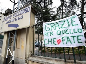 A banner reads "Thank you for what you are doing" next the the entrance of Molinette hospital, on the sixth day of an unprecedented lockdown across of all Italy imposed to slow the outbreak of coronavirus, in Turin, Italy, Sunday, March 15, 2020.