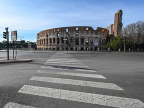 A general view shows a deserted area and a closed Colosseum monument in Rome on March 10, 2020 as Italy imposed unprecedented national restrictions on its 60 million people on March 10 to control the deadly coronavirus.