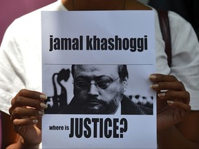 In this file photo taken on October 25, 2018 a member of the Sri Lankan web journalist association holds a placard with the image of Saudi journalist Jamal Khashoggi during a demonstration outside the Saudi Embassy in Colombo on October 25, 2018. (LAKRUWAN WANNIARACHCHI/AFP via Getty Images)