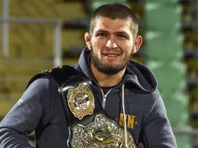 UFC lightweight champion Khabib Nurmagomedov of Russia carries his champions belt as he is escorted by fans upon the arrival in Makhachkala on Oct. 8, 2018.