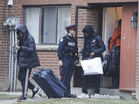 Toronto Police officers escorted kidnapping victim Shammah Jolayemi, 14, and his family from their Driftwood Ave. townhome around 4 p.m. to an undisclosed location on Friday, March 6, 2020. (Jack Boland/Toronto Sun/Postmedia Network)