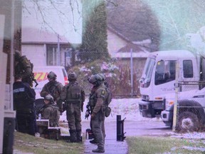 Windsor, Ont., police and Essex County OPP officers at the scene of a standoff with a man inside a residence in the area of McKay Ave. and Rooney St. on March 23, 2020.