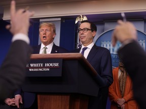 U.S. President Donald Trump and Treasury Secretary Steven Mnuchin answer questions during the daily coronavirus briefing at the White House in Washington March 17, 2020. (REUTERS/Jonathan Ernst/File Photo)