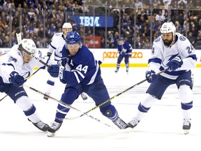 Mikhail Sergachev of the Tampa Bay Lightning (left) tries to catch Maple Leafs’ Morgan Rielly during Tuesday night’s game in Toronto. Rielly returned to the lineup after missing the previous 23 games while recovering from a broken foot. (THE CANADIAN PRESS)