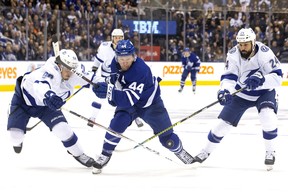 Mikhail Sergachev of the Tampa Bay Lightning (left) tries to catch Maple Leafs’ Morgan Rielly during Tuesday night’s game in Toronto. Rielly returned to the lineup after missing the previous 23 games while recovering from a broken foot. (THE CANADIAN PRESS)