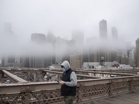 A man wearing a mask walks the Brooklyn Bridge in the midst of the coronavirus (COVID-19) outbreak  on March 20, 2020 in New York City. (Victor J. Blue/Getty Images)