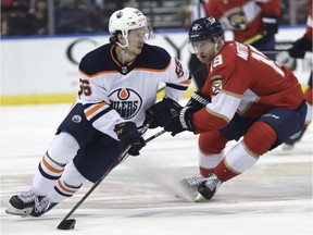Edmonton Oilers right wing Kailer Yamamoto skates with the puck as Florida Panthers defenceman Mike Matheson defends during the first period of an NHL hockey game, Saturday, Feb. 15, 2020, in Sunrise, Fla.