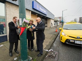 VANCOUVER, B.C.: December 30, 2019 – Flowers are taped to a lamp post in a make-shift memorial for a taxi driver at 1st Avenue and Renfrew in Vancouver, B.C., Dec. 30, 2019.