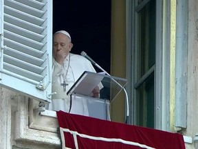 Pope Francis coughs as he leads the weekly Angelus prayer in St Peter's Square at the Vatican, March 1, 2020.