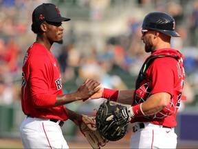 Boston Red Sox relief pitcher Robinson Leyer (77) celebrates with catcher Jonathan Lucroy (25) after beating the Toronto Blue Jays at JetBlue Park. (Sam Navarro-USA TODAY Sports)