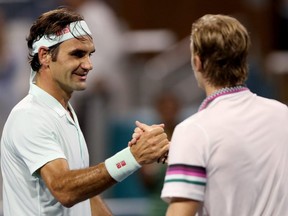 Roger Federer is congratulated by Denis Shapovalov after their match during the Miami Open men's semifinals at Hard Rock Stadium in Miami Gardens, Fla., on March 29, 2019.