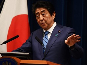Japanese Prime Minister Shinzo Abe talks to the media during a press conference in Tokyo on Saturday, March 14, 2020.