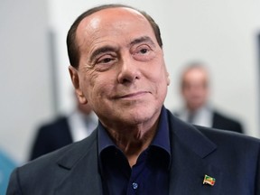 Former Italian PM and leader of the right-wing party Forza Italia Silvio Berlusconi leaves a polling station after casting his vote in Milan on May 26, 2019.
