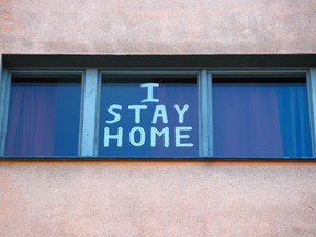 A sign is seen at a residential building in Berlin March 25, 2020, as the spread of the coronavirus continues. (REUTERS/Fabrizio Bensch)