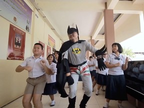 Thai teacher Worrawut Lakchai dressed as a batman sings and dances in fight against coronavirus disease (COVID-19) in Udon Thani province, Thailand in this screen grab obtained by Reuters from social media undated video, on March 18, 2020. (YOUTUBE/HUGIDEA /via REUTERS)