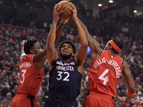 Minnesota Timberwolves centre Karl-Anthony Towns (32) tries to score between Toronto Raptors forwards OG Anunoby (3) and Rondae Hollis-Jefferson (4) at Scotiabank Arena. (Dan Hamilton-USA TODAY Sports)