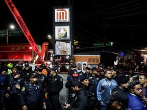 Police officers and onlookers stand outside the Tacubaya metro station, after several people were injured when two trains collided in the underground metro network, in Mexico City, Mexico, on March 11, 2020.