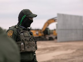 A U.S. Border Patrol agents stands near a section of privately-built border wall under construction on December 11, 2019 near Mission, Texas. (John Moore/Getty Images)