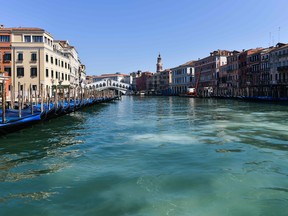 A general view shows clear waters of the Grand Canal near the Rialto Bridge in Venice on March 18, 2020, as a result of the stoppage of motorboat traffic. (ANDREA PATTARO/AFP via Getty Images)