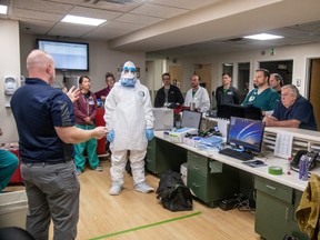 Members of the West Virginia National Guard's special response teams provide hands-on Personal Protective Equipment instruction to the staff of Cabell Huntington Hospital to help prepare the facility for potential future cases of novel coronavirus, in Huntington, West Virginia, on March 11, 2020.