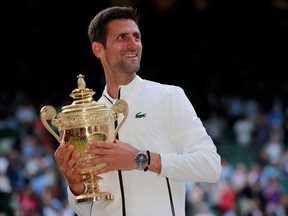 Novak Djokovic celebrates with the trophy as he celebrates winning the 2019 Wimbledon final against Switzerland's Roger Federer. (REUTERS/Andrew Couldridge)