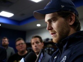 Winnipeg Jets forward Adam Lowry speaks to reporters earlier this season. The Winnipeg Jets closed their dressing room to the media on Monday amid growing concern over the coronavirus.