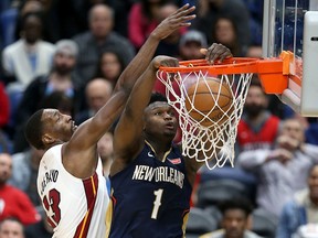 New Orleans Pelicans forward Zion Williamson (1) dunks against Miami Heat forward Bam Adebayo (13) at the Smoothie King Center. (Chuck Cook-USA TODAY Sports)
