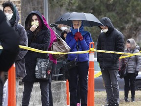 The lineups start forming as Torontonians await their turn to enter the COVID-19 Assessment Centre at Centre at Sunnybrook Hospital in Toronto this morning on Tuesday March 17, 2020. (Stan Behal/Toronto Sun/Postmedia Network)