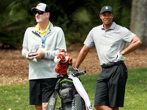 Tiger Woods of the United States (right) and caddie Joe LaCava look on during a practice round for The PLAYERS Championship on The Stadium Course at TPC Sawgrass on March 13, 2019 in Ponte Vedra Beach, Florida.  (Michael Reaves/Getty Images)