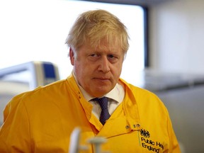 Britain's Prime Minister Boris Johnson visits a laboratory at the Public Health England National Infection Service in Colindale on March 1, 2020 in London.