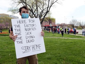 Alec Overmann, a supporter of the stay-at-home order, demonstrates at a protest against the order at the Country Club Plaza on April 20, 2020 in Kansas City, Miss.