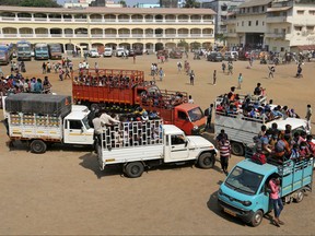 Indian fishermen, who said they were refused entry at two ports after a nationwide lockdown was imposed to fight the coronavirus disease (COVID-19), board vehicles to reach their homes after travelling in the Arabian Sea to reach to their home state Maharashtra from the western state of Gujarat, in Dahanu in Palghar district in Maharashtra, India, April 17, 2020.