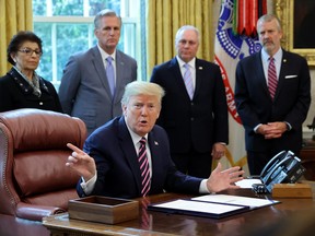 U.S. President Donald Trump talks to reporters after signing the Paycheck Protection Program and Health Care Enhancement Act financial response to the coronavirus disease (COVID-19) outbreak, in the Oval Office at the White House in Washington, D.C., April 24, 2020.