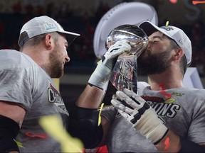 Laurent Duvernay-Tardif (right) of the Kansas City Chiefs celebrates with the Vince Lombardi Trophy after defeating the San Francisco 49ers in Super Bowl LIV this year.