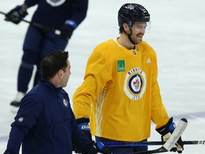 Winnipeg Jets' Adam Lowry (right) had just returned from injury when the pandemic hit.