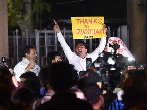 Am indian man holds a placard and shout slogans outside the gates of Tihar Jail after the execution of four men convicted in the gang-tape and murder of a student in 2012, in New Delhi on March 20, 2020.
